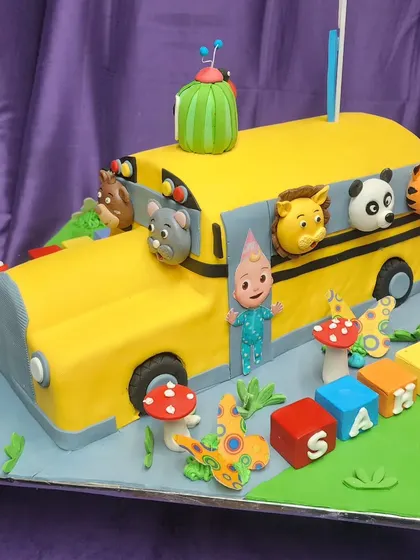 The wheels on the bus go round and round! This fully 3D Cocomelon school bus cake is a showstopper for any toddler's birthday party, featuring JJ and his animal friends ready for a fun ride.