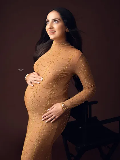 A warm, gentle portrait against a brown backdrop. I'll teach you how to use different colored backgrounds to complement skin tones and outfits.