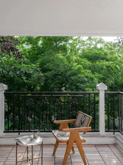 My classic 'Malben' chair enjoying a view from the balcony. Its sturdy teak construction makes it suitable for covered outdoor spaces, blending seamlessly with nature.