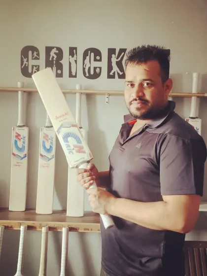 A happy customer holding his new CN CRIC bat at our store. It's important to feel the bat in your hands, and we help players find the perfect match.