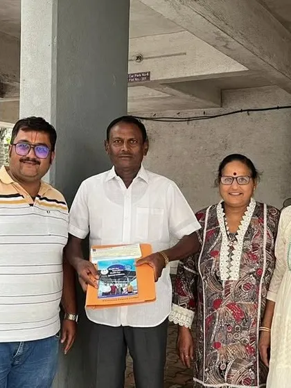 Our team with a group of customers, holding our solar guide.