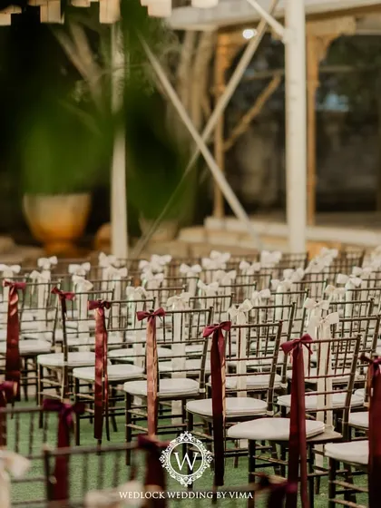 Simple yet elegant details like these chair ribbons and floral arrangements can transform a space. For this reception, we used purple florals and lanterns to create a romantic ambiance.