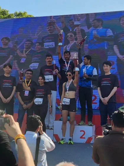 On the podium at the Honda Manesar Half Marathon. Standing here is a reward for all the early mornings and tough workouts.