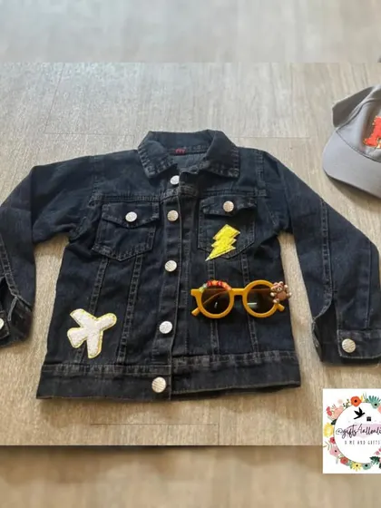 A custom jacket with a lightning bolt and airplane patch, perfect for a little adventurer.