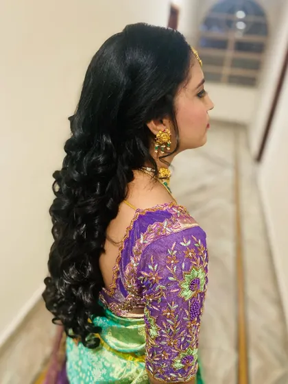Gorgeous, bouncy reception curls. This open hairstyle is perfect for showing off long hair and adds a touch of glamour to any outfit.