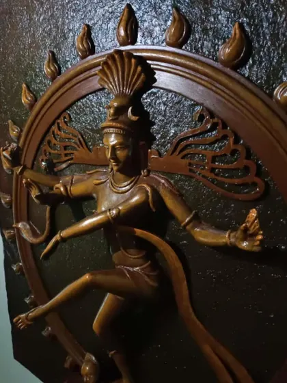 A close-up of the Natraj mural, focusing on the upper body and the circle of fire. The details in the hair and expression are meticulously carved to convey motion and power.