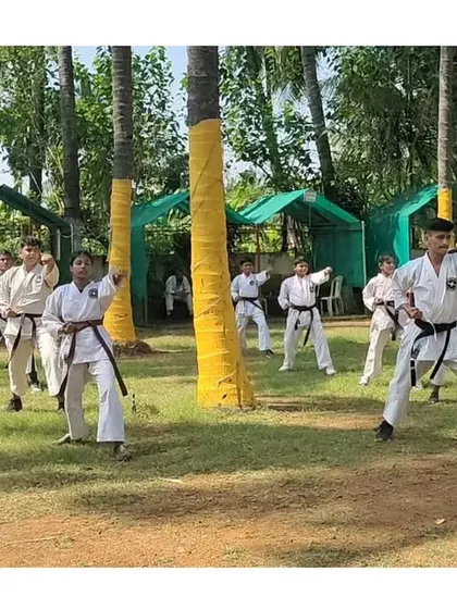 Black belt students practicing their kata amidst the palm trees at our winter training camp. The focus remains sharp regardless of the location.