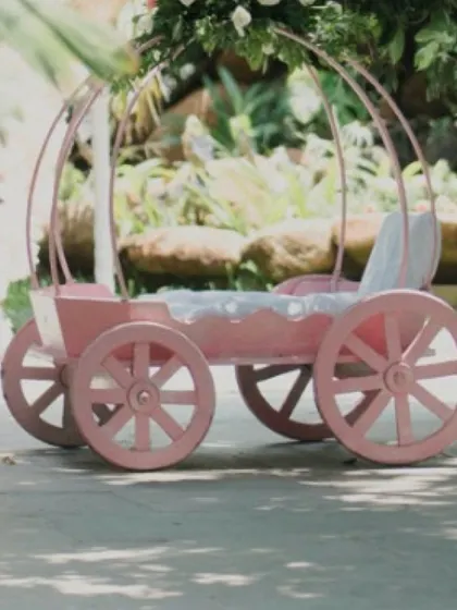 A close-up of a custom-built pink princess carriage. This prop is perfect for photos and adds an authentic touch to any fairytale-themed birthday party.