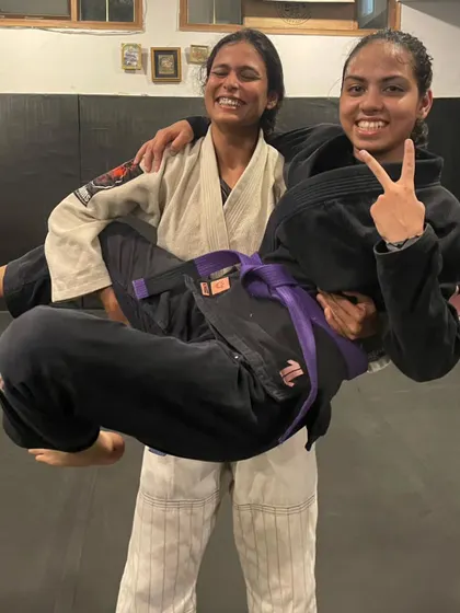 The bond between teammates is strong. A fun moment celebrating a hard-earned purple belt. We support each other, literally.