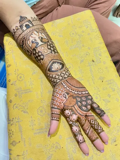 A beautiful bridal arm piece with peacocks and a central lotus eye motif.