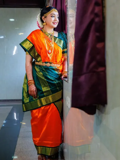 This is the traditional Iyengar Madisar, a nine-yard saree drape that is rich in cultural significance. I am an expert in creating this intricate style, ensuring it is draped authentically and comfortably for important ceremonies.