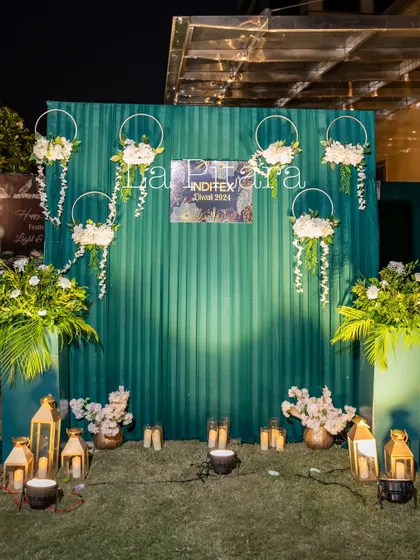 We created a stylish photo wall with a ribbed green panel, branded with the company's logo. It was decorated with hanging floral hoops and an assortment of traditional lanterns on the floor.
