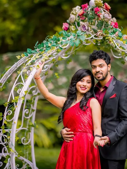 A happy and romantic shot of a couple by a flower-adorned Cinderella carriage. This setup is perfect for capturing the joy and excitement of the pre-wedding season.