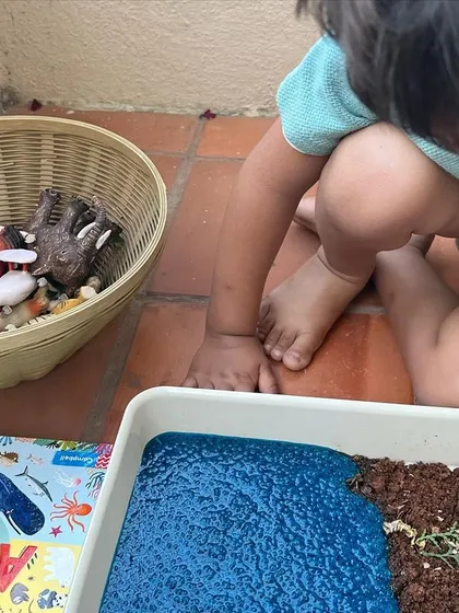 A child deeply engaged in our animal habitat activity. We believe in letting children lead the play, allowing them to explore the materials and concepts at their own pace.