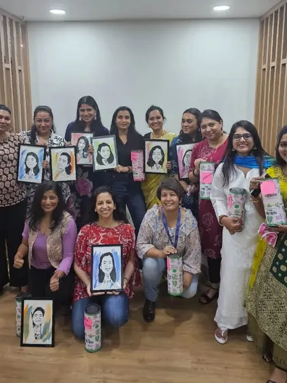 A group photo from the Pidilite Women's Day event, with everyone holding their custom caricatures. It was an honor to be part of their celebration.