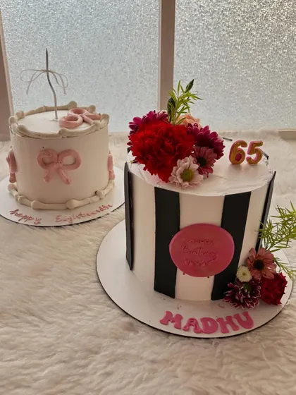 A duo of birthday cakes. One is a chic black-and-white striped cake with fresh flowers for a 65th birthday, and the other is a delicate bow-themed cake for an 18th.