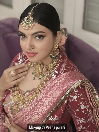 A captivating close-up. This shot highlights the sharp, winged eyeliner and flawless base that define this elegant traditional look.