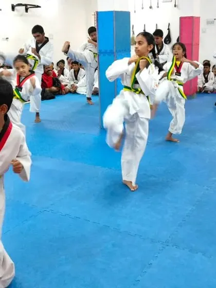 A student in mid-kick during a practice session.