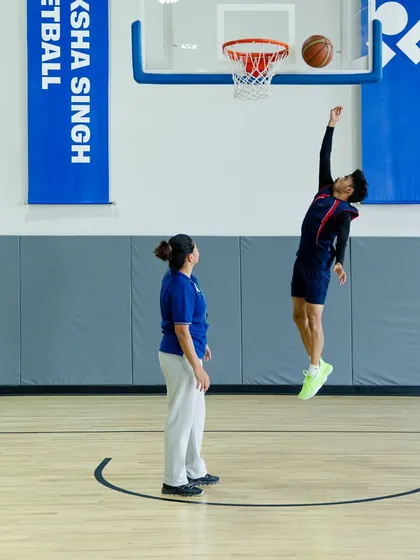 Another player perfecting his layup, reaching for the sky.