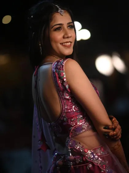 A back view of this guest's beautiful outfit, showing how the hairstyle and makeup work together to create a complete, polished look.