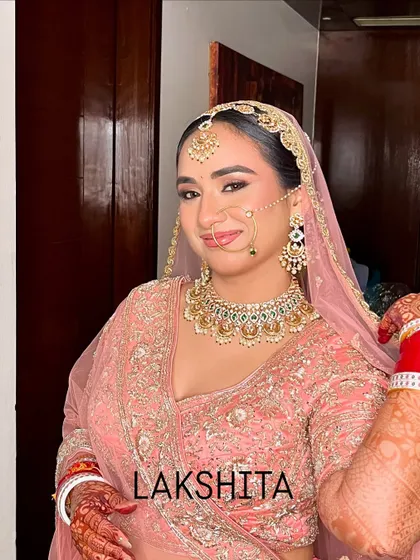 Radiating a bridal glow in a beautiful pink lehenga. This look is all about soft, romantic makeup with shimmering eyes and a matching pink lip tone.