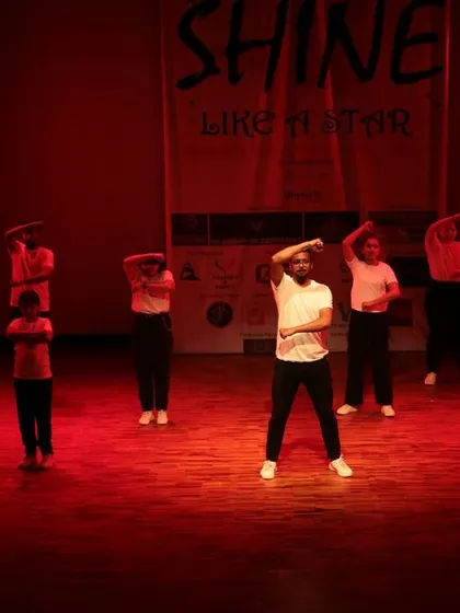 A synchronized arm movement from the group.