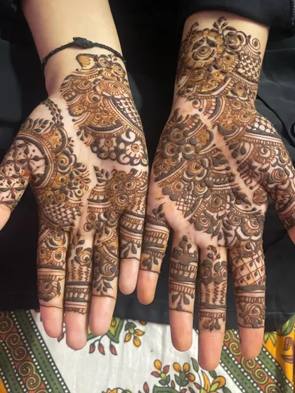 I did this intricate design for a dear friend. It features a mix of paisleys, grids, and delicate vine work that covers the entire palm.