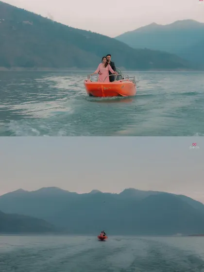 A wide shot showing the couple on a boat, emphasizing the vastness and beauty of the lake and mountains surrounding them during their pre-wedding shoot.