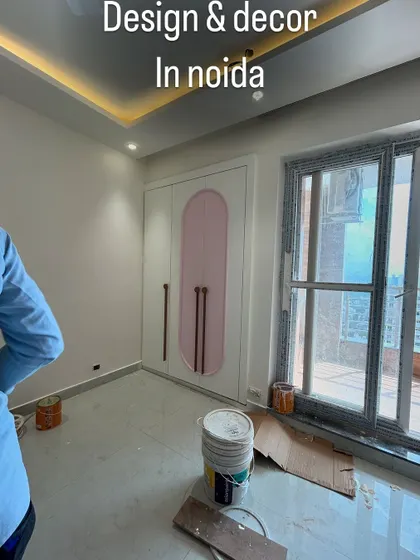 A view of the white and pink wardrobe during installation. The design is perfect for a kid's room, combining functionality with a fun aesthetic.