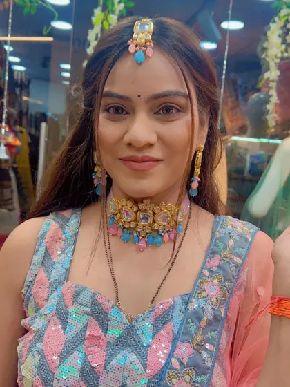 A close-up of a client wearing a modern lehenga with a geometric sequin blouse in shades of pink and blue.
