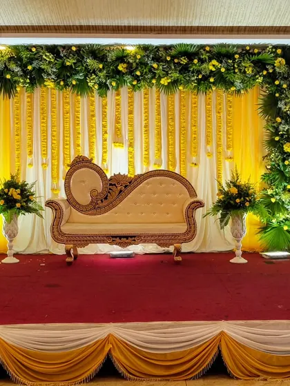 A yellow and green floral stage, perfect for a Haldi or daytime engagement.
