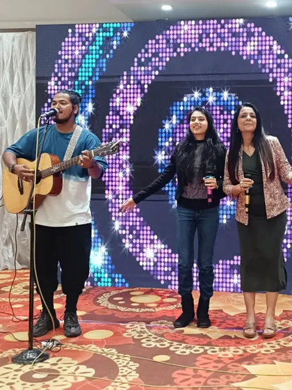 Singing along with the band and a young guest. I love to encourage participation and make the entertainment interactive for all age groups.