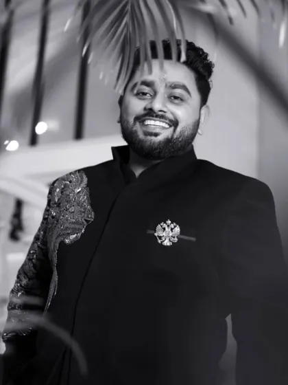 A classic black and white portrait of the groom. This shot captures his confident smile and charm, a timeless image he'll look back on for years to come.