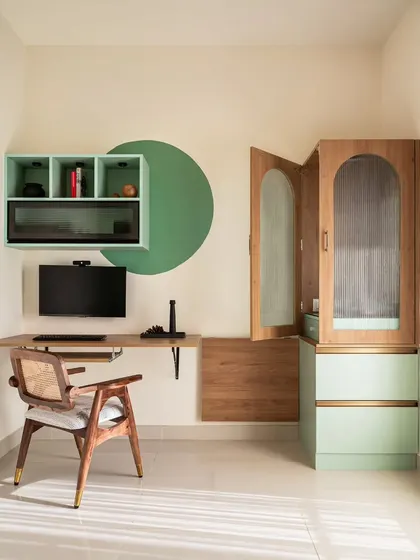 This study area features a cleverly designed desk that splits into two. The portion adjacent to the puja unit folds away, allowing for easy access to the sacred space without compromising the workspace.