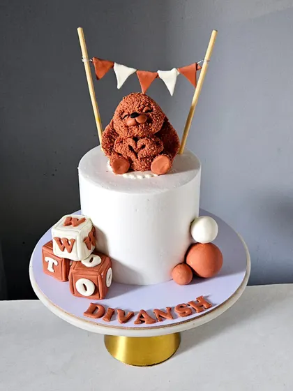 The full view of the bunny cake, which also includes a small bunting topper, adding to its simple charm.