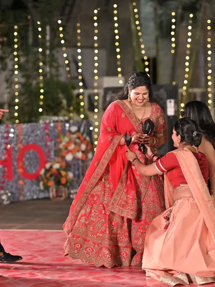 A fun moment on the dance floor as friends and family gather around the bride during a Sangeet performance.