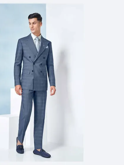 Confidence is the best accessory for any suit. This blue plaid double-breasted suit is tailored to give you just that, with a powerful silhouette and impeccable fit.