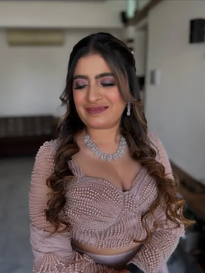 A close-up of a soft, romantic makeup look. The pink eyeshadow and nude lip are a classic combination that suits any occasion.