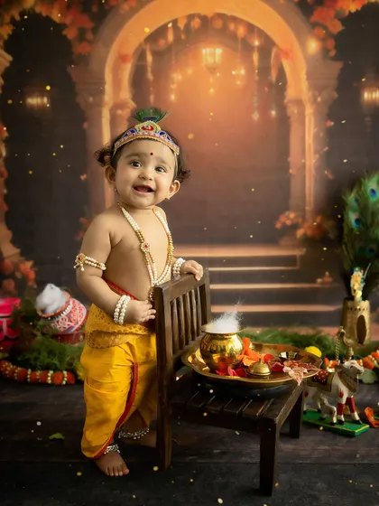 Our little Krishna stands tall. Using props for support, we can capture older babies in a variety of poses during our themed milestone sessions.
