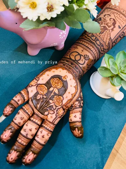 A beautifully styled shot of my bridal mehendi work. The design includes a couple portrait on the arm and a floral motif on the palm, perfect for capturing memories.
