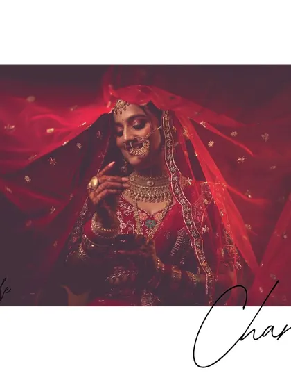 A creative bridal portrait with the bride's name in script, framed by her flowing red veil.