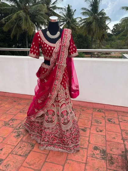 This is a glimpse of one of my premium bridal lehengas available for rent. The intricate velvet embroidery and rich magenta color make it a luxurious choice for a bride on her wedding day.
