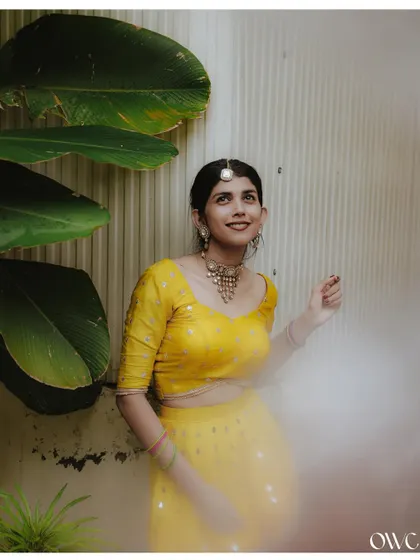 An ethereal portrait of the bride in her yellow attire, with a soft, misty effect adding to the dreamy quality.