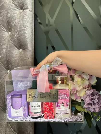 This hand-held shot shows the portability and stylish design of our acrylic hamper. It's a gift that looks as good as the thoughtful items inside it.