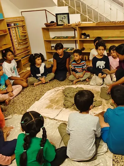 Back in the classroom, we gather in a circle to learn how to process the harvested clay, preparing it for sculpting by removing impurities.