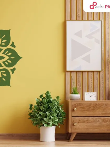 This vibrant yellow wall with a green partial mandala stencil shows how colour and design can work together to create a cheerful and stylish space.
