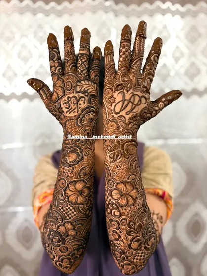 A beautiful full-arm design featuring personalized initials hidden within the dense floral and paisley patterns.