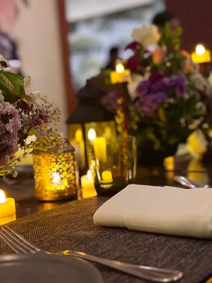 We believe in bringing minimalism and elegance to the table. This close-up shows our beautiful floral and candle arrangements for an intimate dinner party.