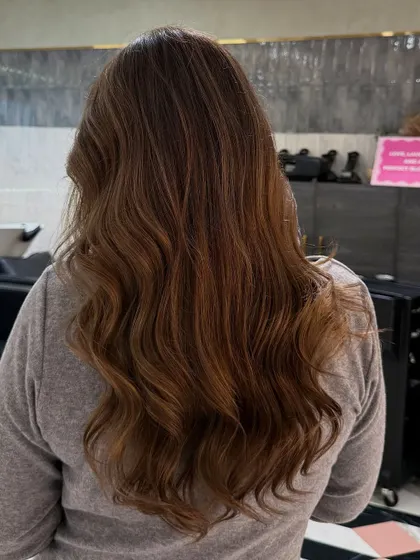 A cool-toned, deep ash blonde that looks stunning and natural on darker hair. The soft, subtle glow is perfect for a sophisticated look.
