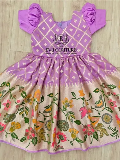 A one-piece frock with a unique Paithani and Kalamkari print combination. The bodice has a diamond pattern, and the skirt features colorful birds and flowers.
